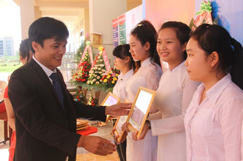 Hiệu trưởng nhà trường Nguyễn Thái Bình tặng Giấy khen cho học sinh đạt thành tích trong học tập.