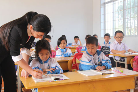 Cô giáo Trường Tiểu học Bùi Thị Xuân (TP. Buôn Ma Thuột) tận tình hướng dẫn học sinh lớp 1 tập đọc.
