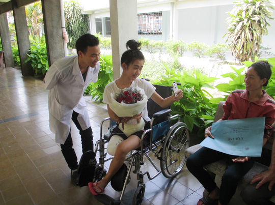Lê Thị Hà Vi với bác sĩ của Bệnh viện Chỉnh hình và Phục hồi chức năng. Ảnh: ANH THƯ