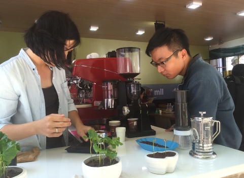 Một du khách chăm chú tìm hiểu cách pha chế cà phê qua máy espresso
