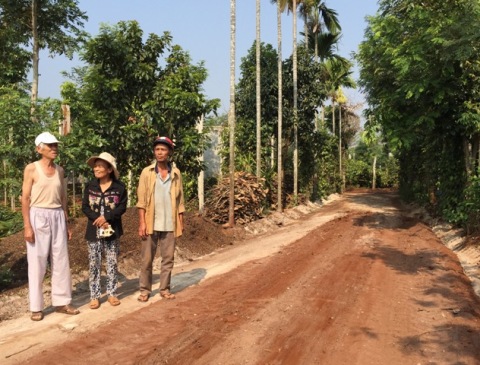 Ông Nguyễn Tấn Phát (ngoài cùng, bên trái) trên phần đường trước đây là đất của gia đình mình.