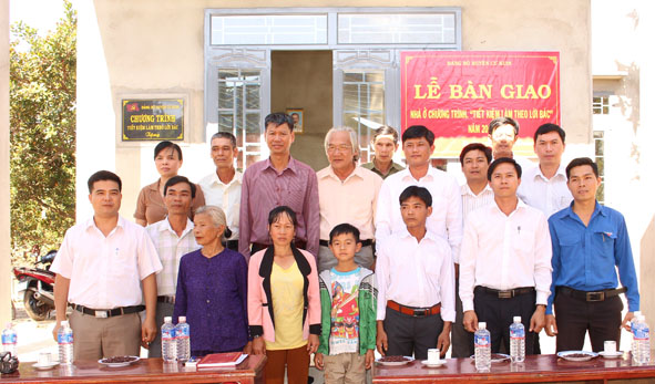 Đại diện  lãnh đạo huyện  Cư Kuin  trao nhà tặng  người dân  theo  chương trình “Tiết kiệm làm theo  lời Bác”. 